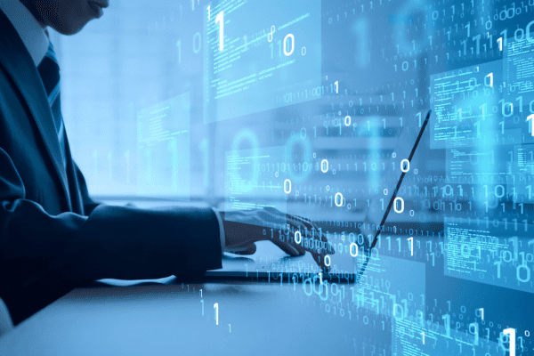 A man at a laptop with computer language overlaid