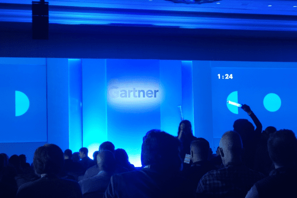 People waiting before a stage that says "Gartner"